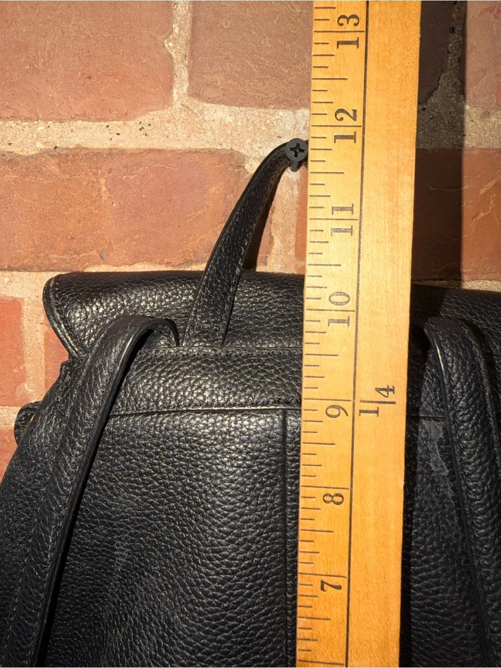 kate spade black pebbled leather flap drawstring backpack